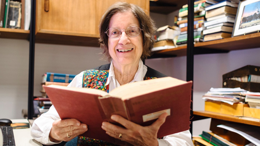 photo of librarian Donna Arnold, holding a book