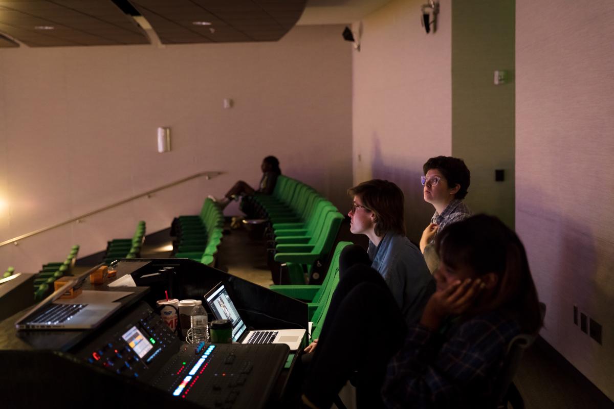 people sitting with laptops and technical equipment