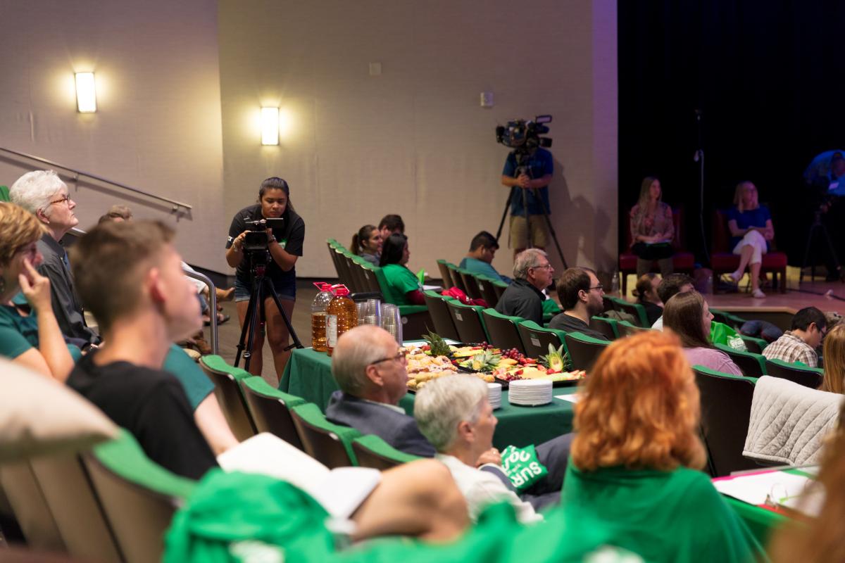 people sitting in seats and at a table