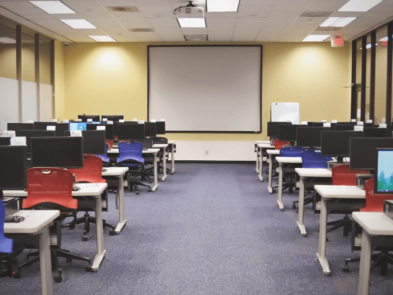 computer classroom with computer stations and presentation screen