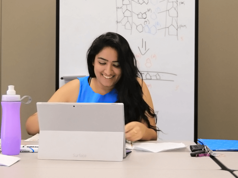 smiling woman looking at her laptop