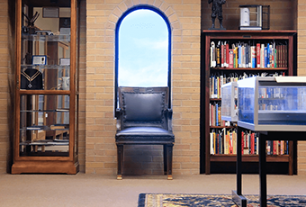 room with a chair and two bookcases